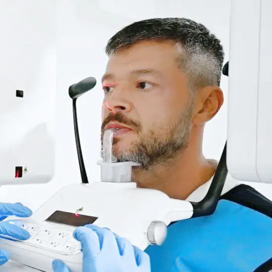 Victor Slav undergoing a panoramic dental X-ray at Lara Smile Dental Clinic.