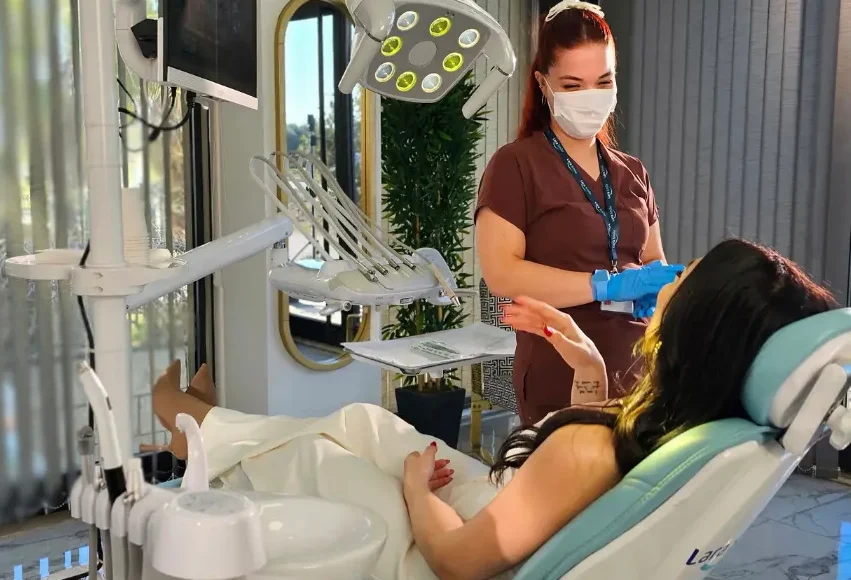 A dentist performing a dental procedure on a patient at Lara Smile Dental Clinic in Antalya, Turkey
